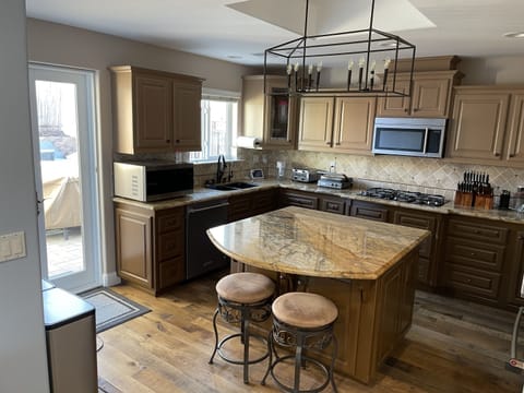 Main house kitchen island looking toward French doors which lead to rear patio.