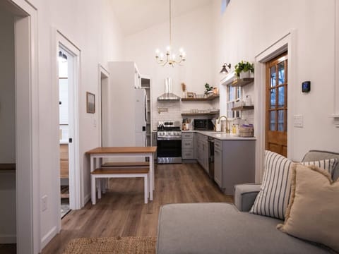 Fully furnished chef's kitchen complete with dishwasher, pullout trashcan, potfiller, gas stove, fridge, and all the cookware and utensils you need.