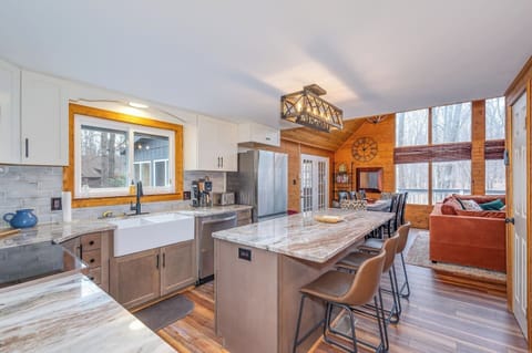 Newly-renovated kitchen shines with stainless Samsung Appliances, 
Dolomite countertops, large farm sink, icemaker, and counter seating for 4.
