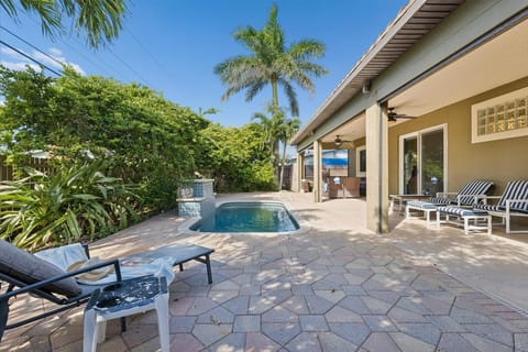 Relax, soak, and unwind! This tropical backyard oasis is perfect for poolside lounging and sunset BBQs!