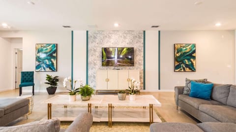 Luxury modern living room with stylish décor, cozy seating, and vibrant accents!