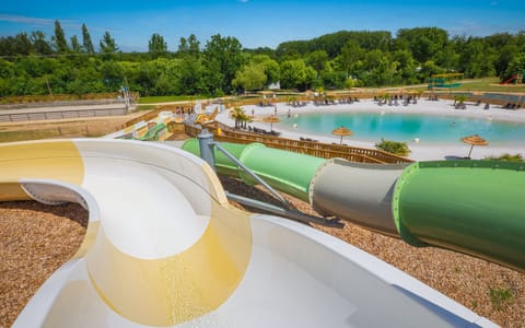 A duo of water slides amidst rolling hills.