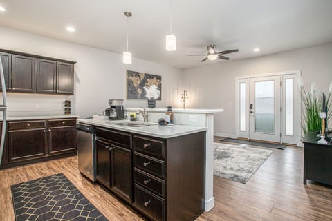 Entertain with ease in our open-concept kitchen, featuring modern appliances, with seamless views of the cozy living area.