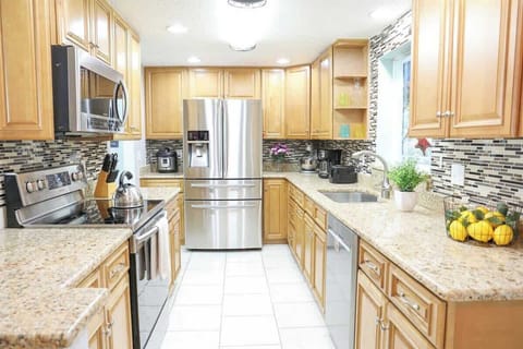 Fully equipped kitchen with very large fridge, dishwasher, coffee maker, toaster, slow cooker and all the needed utensils to make great meals in our License to Chill, Largo vacation rental with heated pool.