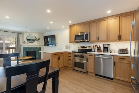 The updated kitchen offers quartz countertops, stainless steel appliances, and plenty of counter space for meal prep.