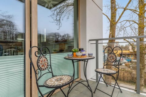 The furnished balcony offers a perfect spot for morning coffee with a view.