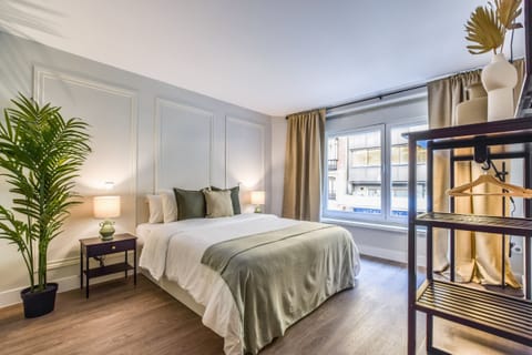 Main view of one of the bedrooms with a double bed and exterior windows