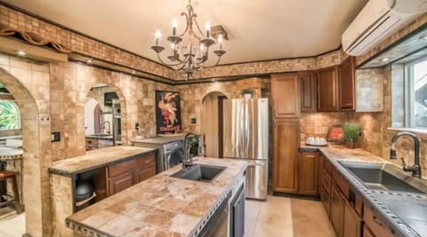 The Prep Kitchen is adjacent to the Chef's Kitchen and includes a second refrigerator, dishwasher, two sinks, large pantries, and front loading washer and dryer.