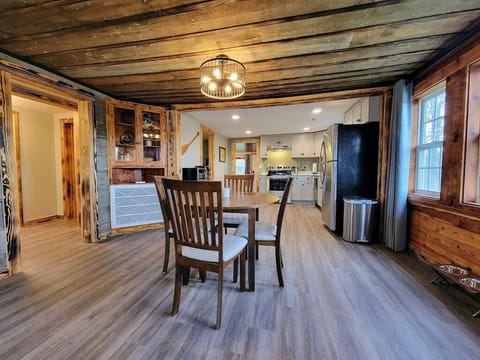 Enjoy the rustic charm of the old cabin with the exposed ceiling and siding