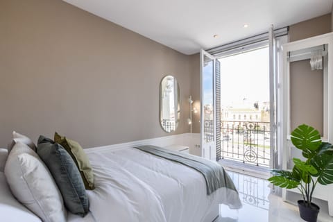 Main view of one of the bedrooms with a double bed and exterior balcony