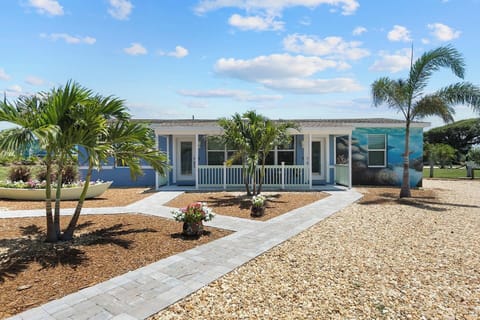 Charming Exterior: Step into paradise with lush landscaping and vibrant ocean-themed decor!