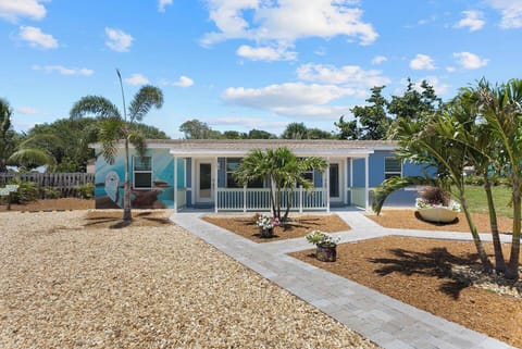 Beautifully landscaped front yard with a rock driveway, parking for one car per unit. Dolphin building, 215 Dolphin is the right hand side unit. 