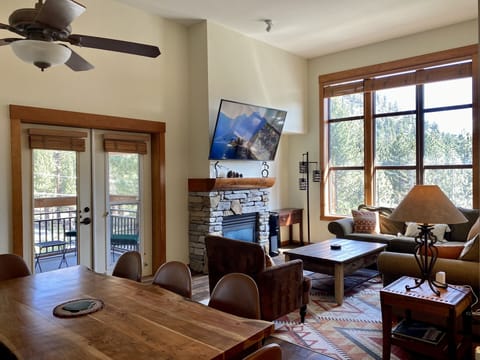 Open floor plan with high ceilings and windows looking out to the mountains