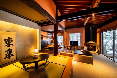 Ochimizu House_The living room seen from the Japanese-style room. Outside the window is a terrace facing the river.