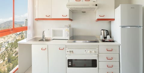 Fridge, microwave, coffee/tea maker, cookware/dishes/utensils