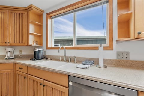 A double-bowled sink and a dishwasher makes clean up after meals easy