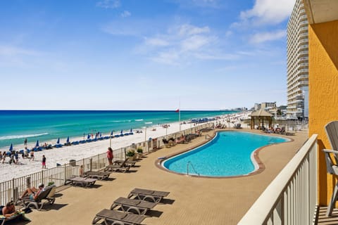 Take in sweeping pool & ocean views from this sunny beachfront vantage point