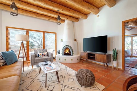 Living room with kiva fireplace, modern furniture, and large flat screen TV