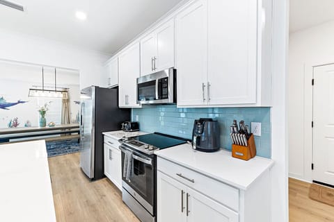 Stainless Steel Appliances w/ Various Kitchen Essentials for Your Personal Experience. Cookware and Silverware are All Stored in the Custom Cabinets