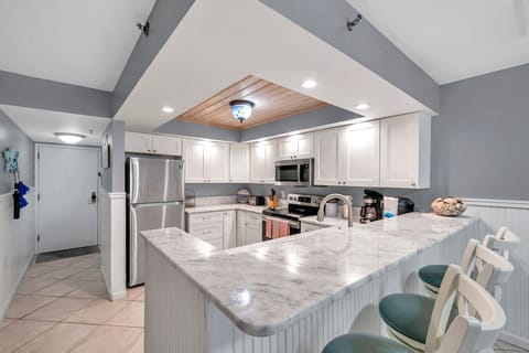 Spacious kitchen w/ large island, clean lines, & plenty of room for cooking together.