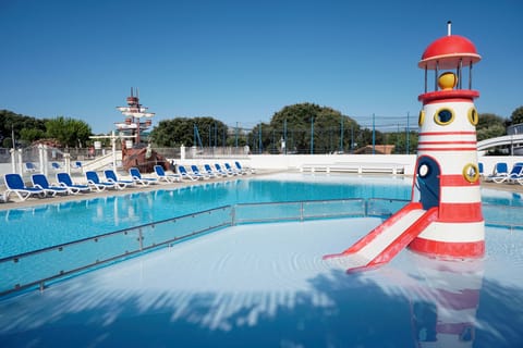 The resort’s signature lighthouse slide adds seaside charm to the family pool.