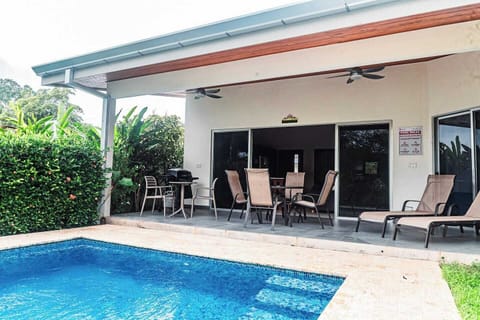  charming home with a spacious pool area and a convenient grilling space 