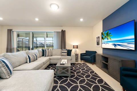 Relax in this spacious living room with a cozy sectional, stylish decor, and a large TV, perfect for unwinding after a day of adventure.