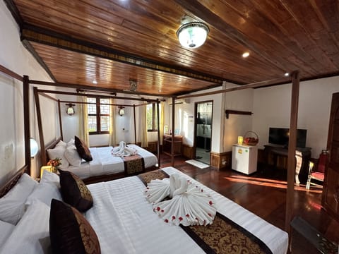 Deluxe Quadruple Room | Living area | 21-inch flat-screen TV with premium channels, TV