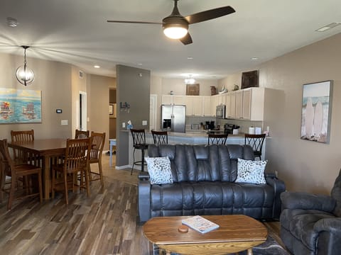 Open concept with view of living area, kitchen and dining.  Note table for 6