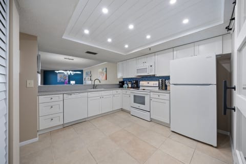 Fully stocked custom kitchen open to the living room.