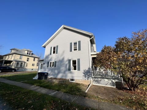 Exterior side view w/ trash and recycling - side door entrance w/ digital lock