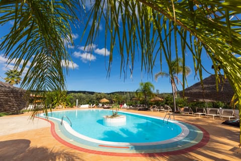 Seasonal outdoor pool, open 8:30 AM to 8:00 PM, pool umbrellas