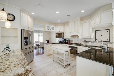Featuring stainless steel appliances, a kitchen island, and plenty of counter space, this kitchen has everything you need to cook up a storm