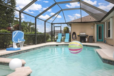 Private screened pool with spa, seating area, and sunny relaxation.