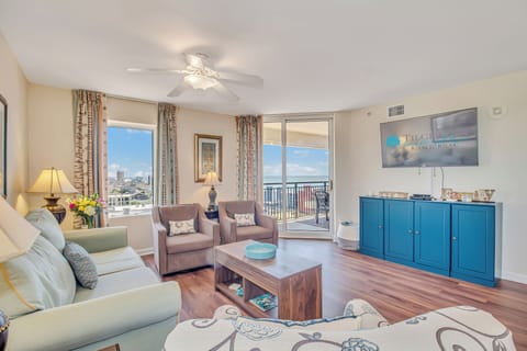 Unwind in your bright living room with plush seating, city views, and that gentle ceiling fan keeping you cool.