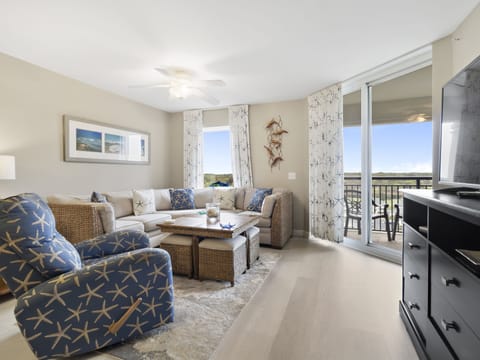 Sink into coastal comfort in your spacious living room, where nautical touches and plush seating create the perfect retreat after beach days.