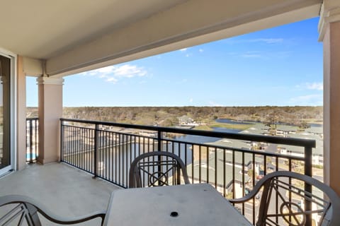 Your private balcony dining space overlooks peaceful countryside and sparkling water views - perfect for morning coffee or evening meals.