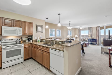 Your spacious kitchen flows seamlessly into a bright living area, where granite counters and modern appliances make meal prep effortless.