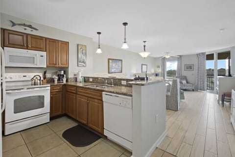 Your spacious kitchen features granite counters and modern appliances, perfect for preparing meals while staying connected to your group.