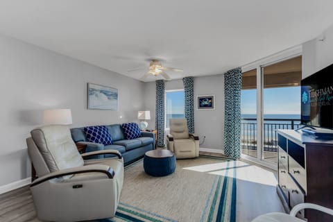 Relax in your beautifully appointed living room with plush seating and stunning ocean views from your private balcony.