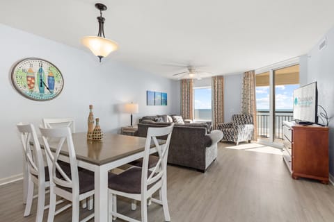 Your bright oceanfront living space combines comfort with stunning sea views through floor-to-ceiling windows.