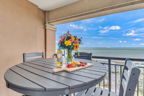 Savor your morning coffee or evening wine on this private balcony, where fresh flowers and panoramic ocean views create the perfect backdrop for relaxation.