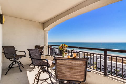 Sip your morning coffee on your private oceanfront balcony with stunning sea views and comfortable seating for ultimate relaxation.