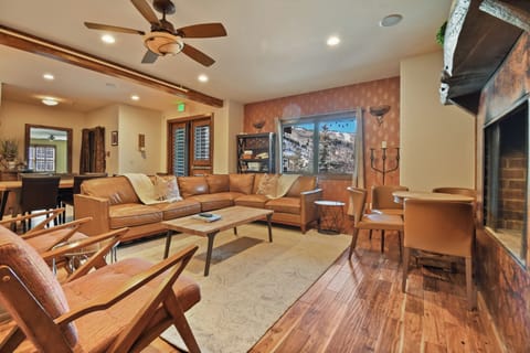 Sink into plush leather seating by your cozy fireplace, where mountain views frame relaxing evenings in this stylish living space.