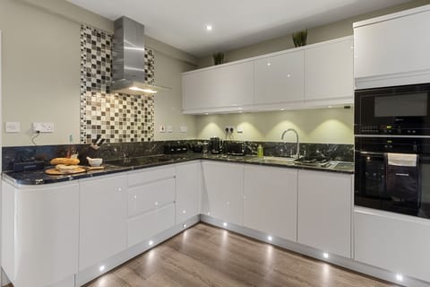 Enjoy preparing meals in the fully equipped kitchen, complete with integrated appliances and a large selection of crockery and glassware