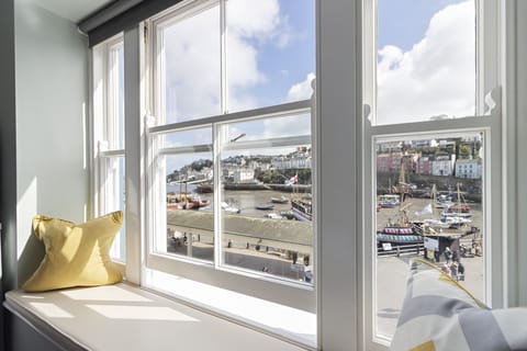 Make the most of the window seat in the living room and enjoy the stunning views of Brixham harbour and beyond