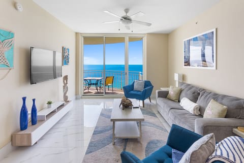 Unwind in your coastal retreat where ocean views stretch endlessly beyond floor-to-ceiling windows, inviting sea breezes through your private balcony.
