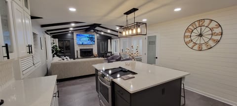 Open concept kitchen into living room w/ 77" OLED TV