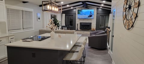 Open concept kitchen into living room w/ 77" OLED TV