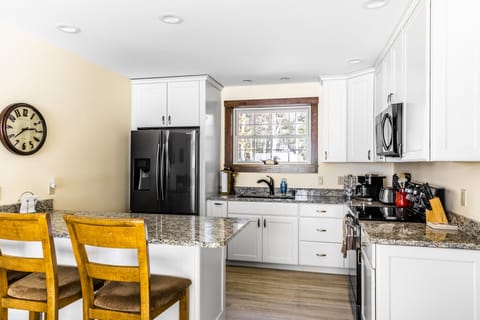 Full kitchen with seating.